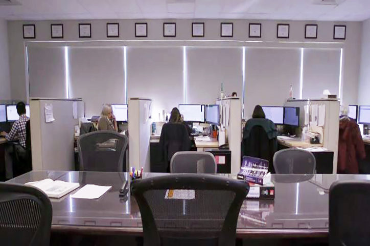 Wide angled photo of poison specialists working in the operations area of the Maryland Poison Center